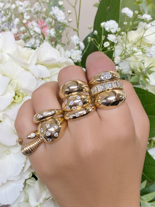 woman wearing various styles of gold and diamond rings